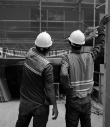 a couple of men wearing hard hats